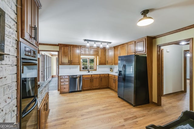 kitchen with refrigerator with ice dispenser, crown molding, sink, dishwasher, and light hardwood / wood-style floors