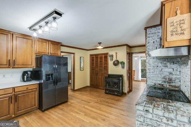 kitchen featuring stainless steel fridge with ice dispenser, crown molding, and light hardwood / wood-style flooring