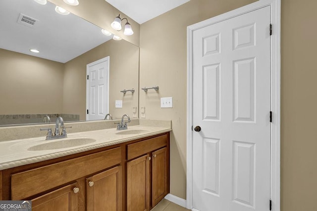 bathroom with tile patterned flooring and vanity