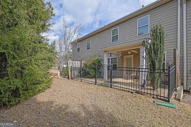 back of property featuring ceiling fan