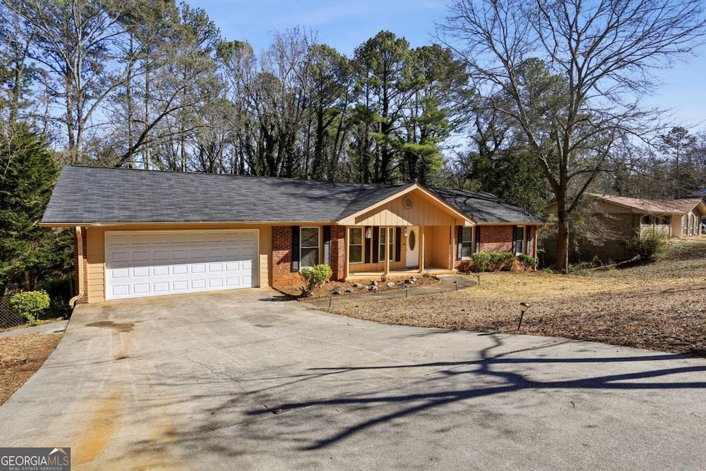 single story home featuring a garage and covered porch