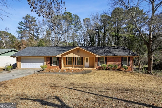 ranch-style home featuring a garage and covered porch