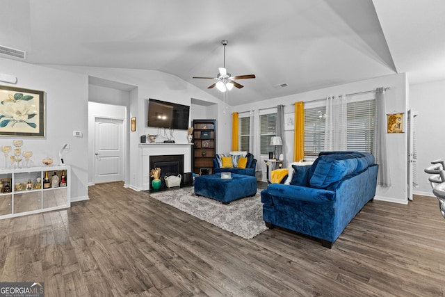 living room featuring ceiling fan, lofted ceiling, and dark hardwood / wood-style flooring