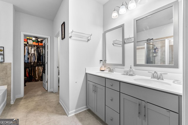 bathroom with vanity, tile patterned floors, and separate shower and tub