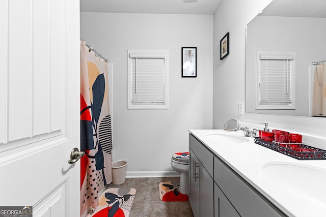 bathroom featuring tile patterned floors, vanity, and toilet