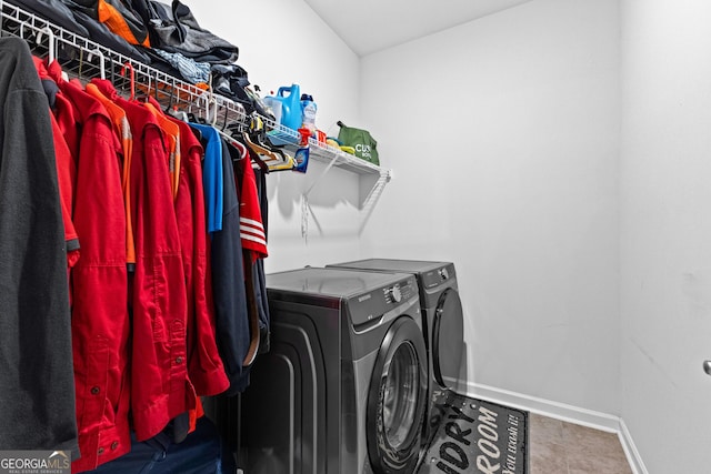 laundry room featuring tile patterned floors and washing machine and dryer