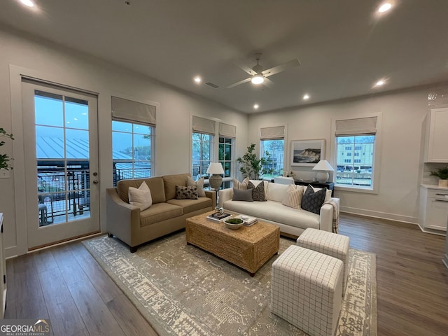 living room with a healthy amount of sunlight, hardwood / wood-style flooring, and ceiling fan