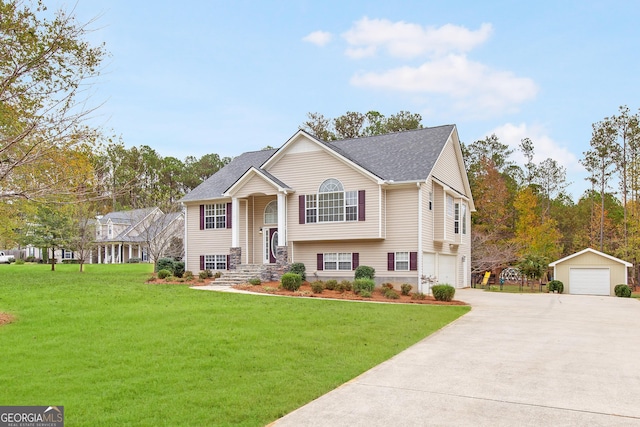 raised ranch with a garage, an outbuilding, and a front yard