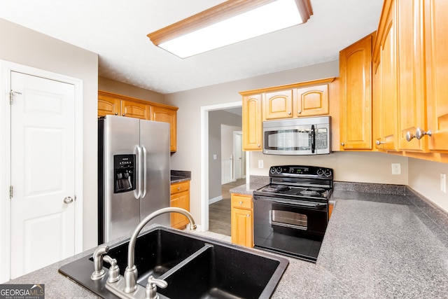 kitchen featuring sink, stainless steel appliances, and light brown cabinets