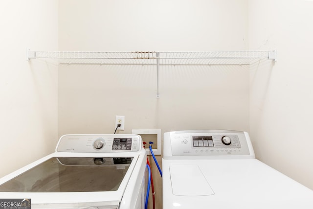 laundry room with washing machine and clothes dryer