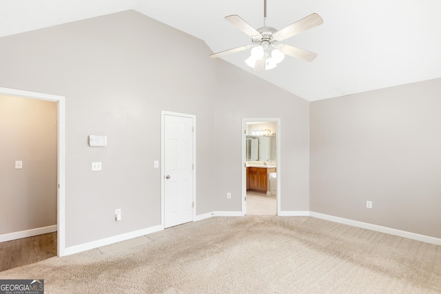 unfurnished bedroom with high vaulted ceiling, light colored carpet, ceiling fan, and ensuite bathroom