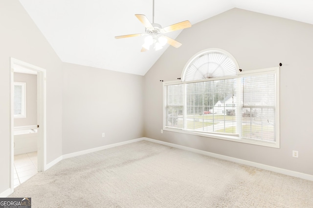 spare room featuring carpet floors, plenty of natural light, high vaulted ceiling, and ceiling fan