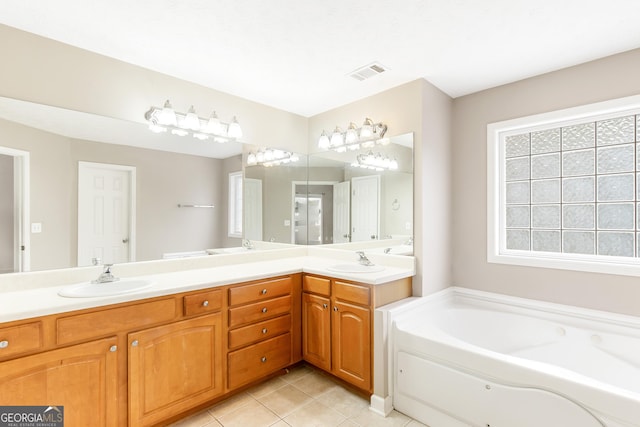 bathroom with tile patterned floors, vanity, and a bath