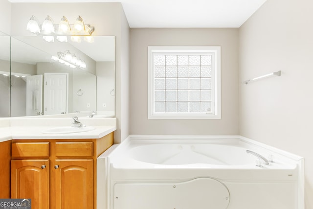 bathroom featuring vanity and a bath