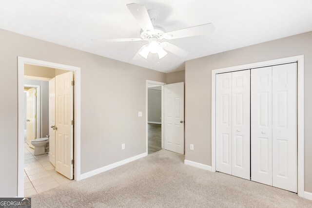 unfurnished bedroom featuring light carpet, connected bathroom, a closet, and ceiling fan