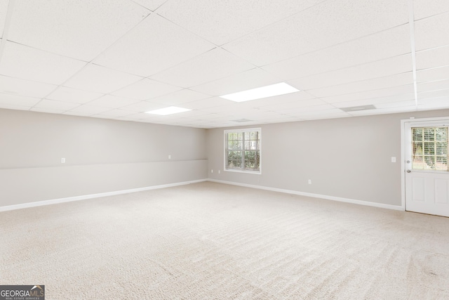 basement featuring carpet flooring and a drop ceiling