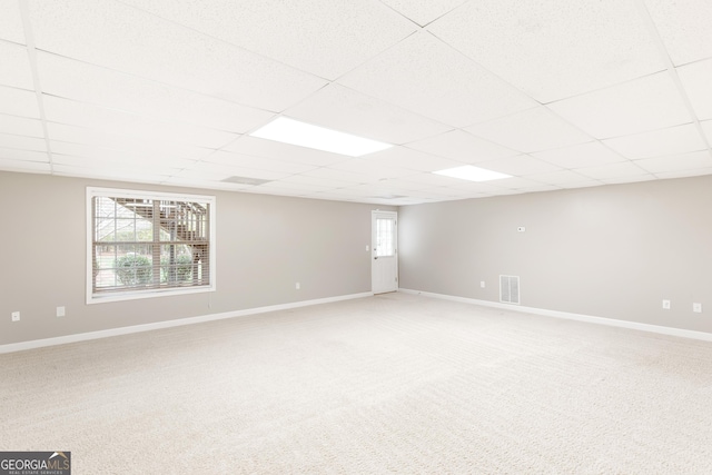 basement with carpet floors and a paneled ceiling