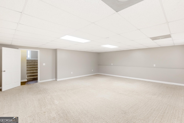 basement with light carpet and a drop ceiling