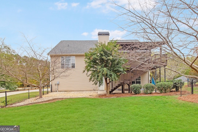 view of front of property with a deck and a front lawn