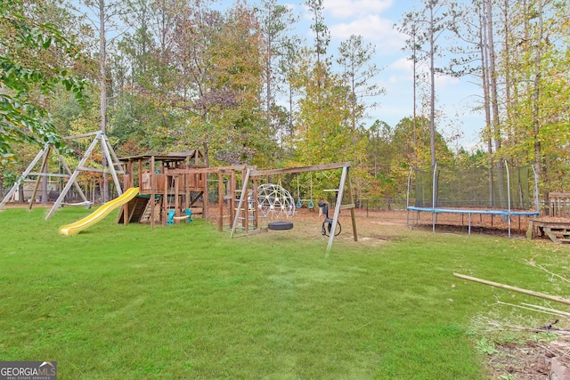 view of playground featuring a trampoline and a lawn