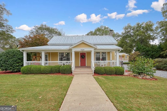 bungalow-style home featuring covered porch and a front lawn