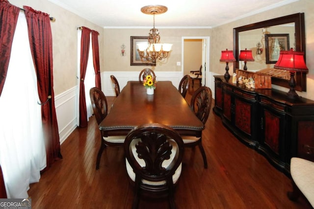 dining space featuring crown molding, wood-type flooring, and an inviting chandelier