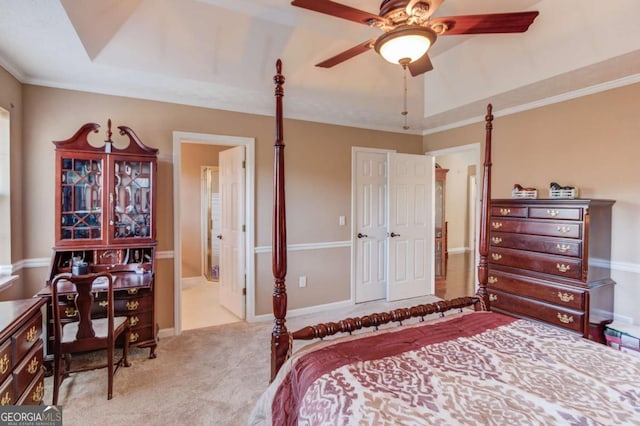 bedroom featuring ceiling fan, light colored carpet, connected bathroom, and a raised ceiling