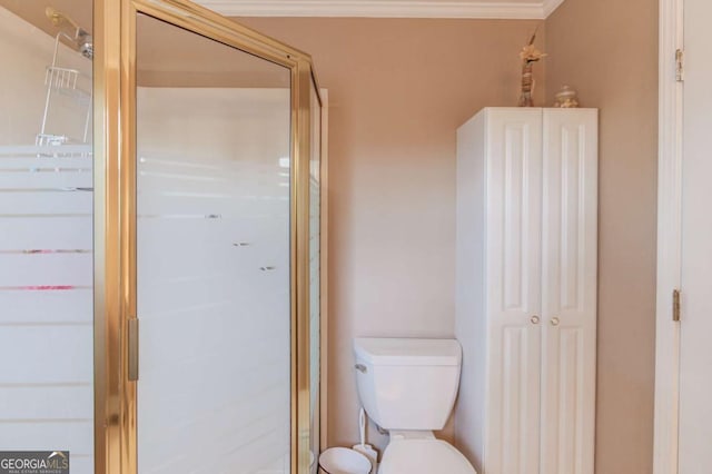 bathroom with a shower with door, ornamental molding, and toilet