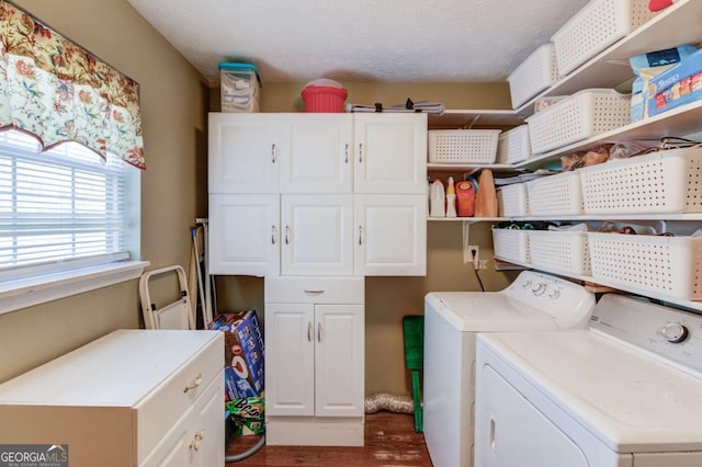 laundry room featuring dark hardwood / wood-style flooring, washing machine and dryer, and cabinets