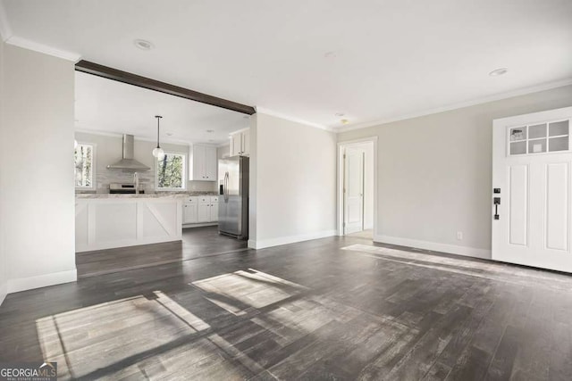 unfurnished living room with ornamental molding and dark hardwood / wood-style floors