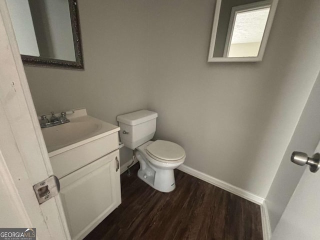 bathroom featuring vanity, hardwood / wood-style floors, and toilet