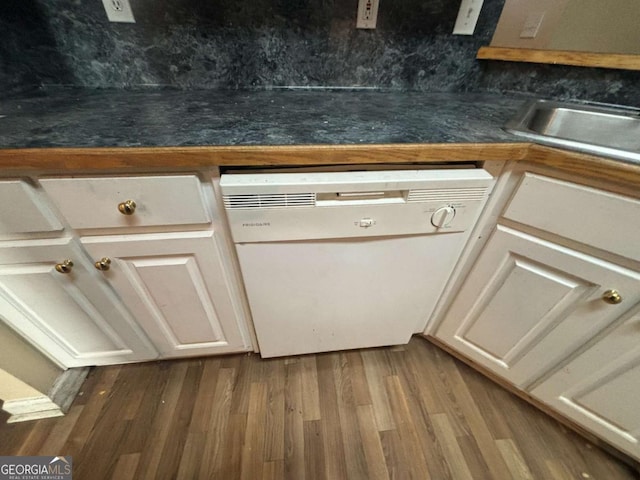 interior space featuring white cabinetry, dark hardwood / wood-style flooring, and dishwasher