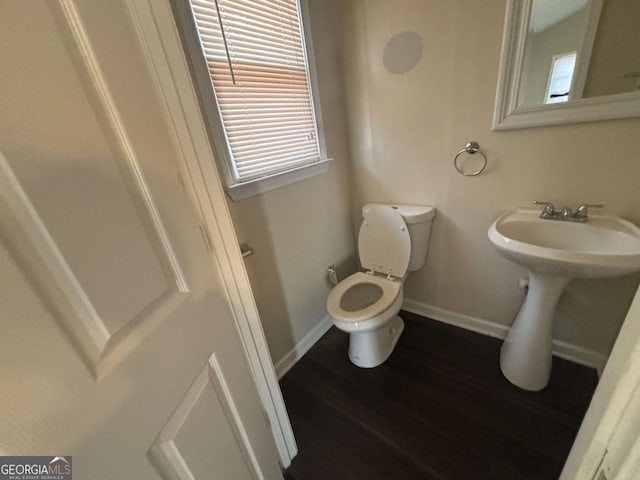 bathroom with wood-type flooring, sink, and toilet