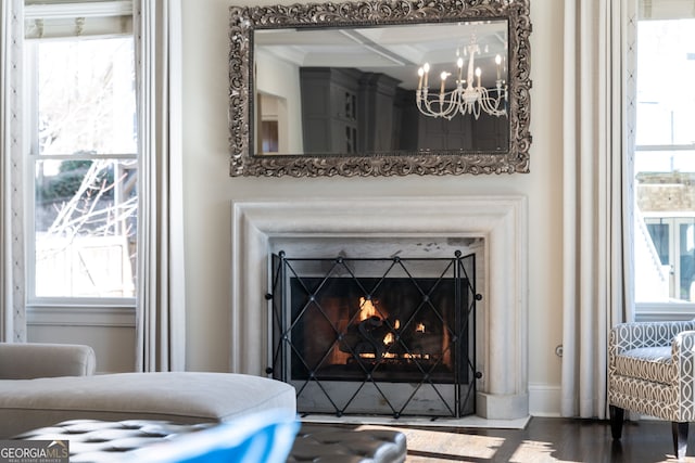 details with hardwood / wood-style floors and an inviting chandelier