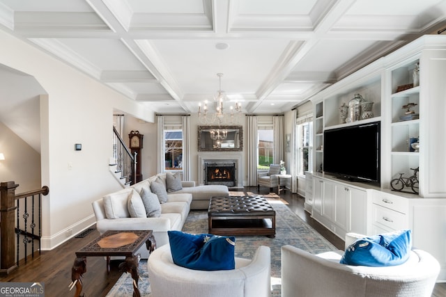 living room with coffered ceiling, a notable chandelier, a fireplace, dark hardwood / wood-style flooring, and beamed ceiling