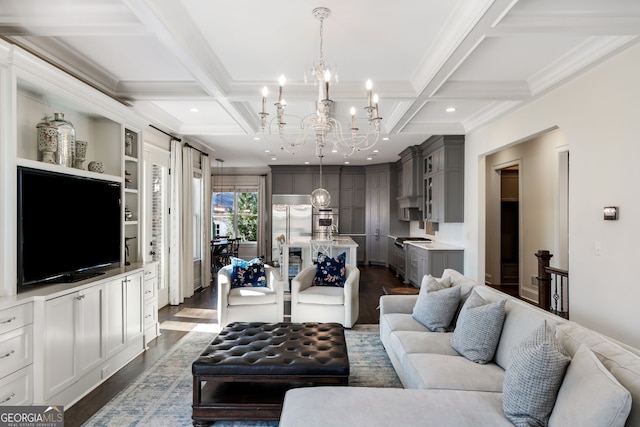 living room with beam ceiling, ornamental molding, coffered ceiling, dark wood-type flooring, and an inviting chandelier