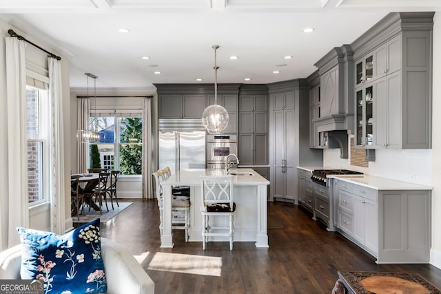 kitchen with pendant lighting, stainless steel appliances, a kitchen bar, and gray cabinetry