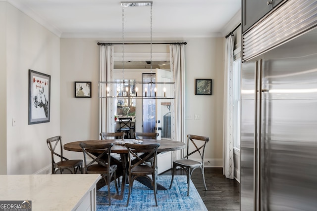 dining area with ornamental molding, dark hardwood / wood-style floors, and a notable chandelier