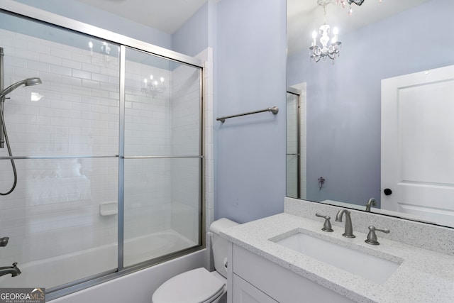 full bathroom with vanity, shower / bath combination with glass door, and toilet