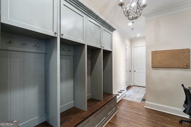 mudroom with crown molding, dark hardwood / wood-style floors, and a chandelier