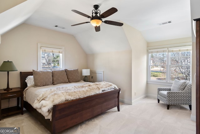 bedroom featuring ceiling fan, light colored carpet, and vaulted ceiling