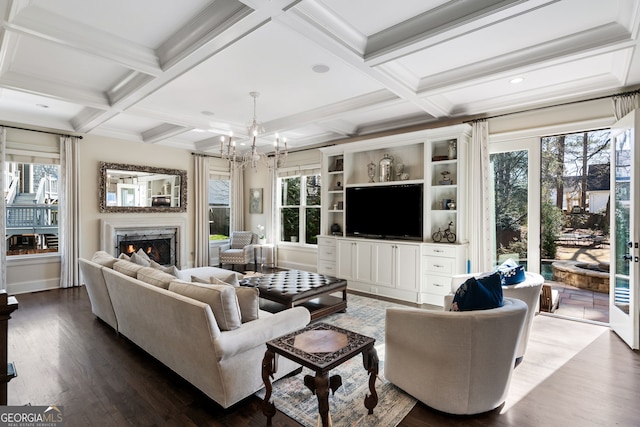 living room with coffered ceiling, beamed ceiling, a chandelier, hardwood / wood-style flooring, and a fireplace