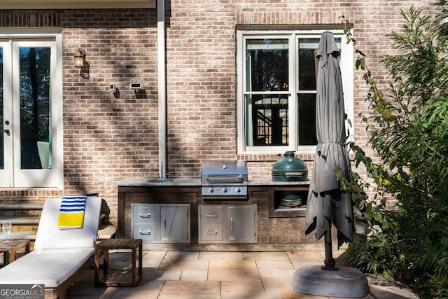 view of patio with a grill, sink, and an outdoor kitchen