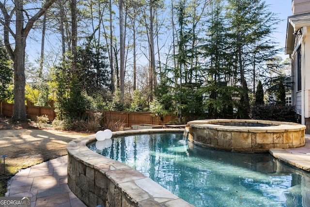 view of pool with an outdoor hot tub and pool water feature