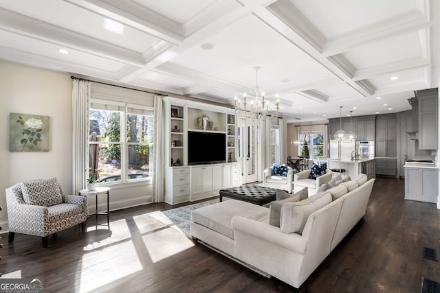 living room featuring beamed ceiling, coffered ceiling, dark wood-type flooring, and a notable chandelier