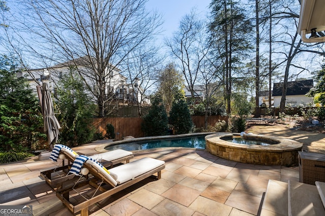 view of pool with an in ground hot tub and a patio