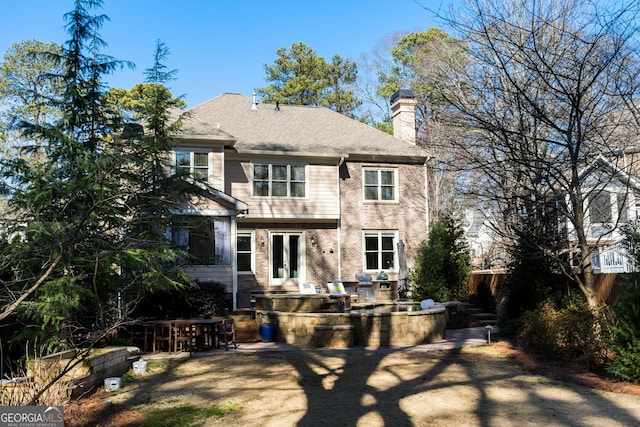 rear view of house with french doors and a patio area