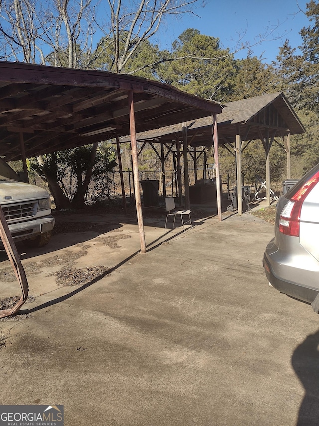 view of parking / parking lot featuring a carport