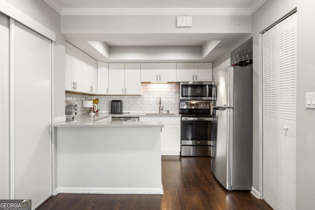 kitchen with sink, crown molding, appliances with stainless steel finishes, dark hardwood / wood-style flooring, and white cabinets