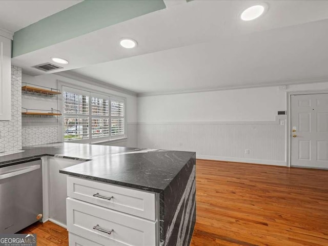 kitchen featuring tasteful backsplash, dishwasher, white cabinets, and light hardwood / wood-style floors